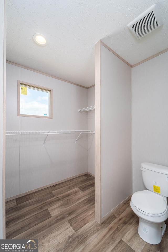 92 Wood Duck Ln, Folkston, GA 31537 - bathroom featuring visible vents, a textured ceiling, wood finished floors, and toilet