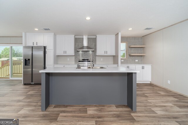 92 Wood Duck Ln, Folkston, GA 31537 - kitchen with visible vents, light countertops, wall chimney exhaust hood, a sink, and appliances with stainless steel finishes
