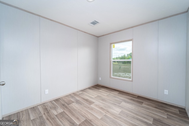 92 Wood Duck Ln, Folkston, GA 31537 - empty room featuring light wood-style floors, ornamental molding, a decorative wall, and visible vents