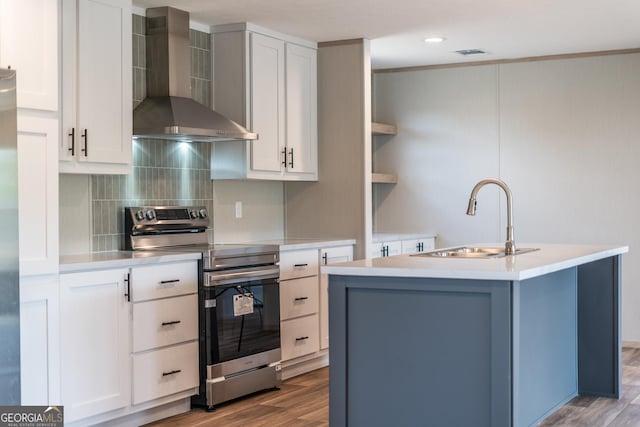 92 Wood Duck Ln, Folkston, GA 31537 - kitchen with a sink, light countertops, wall chimney exhaust hood, electric stove, and wood finished floors