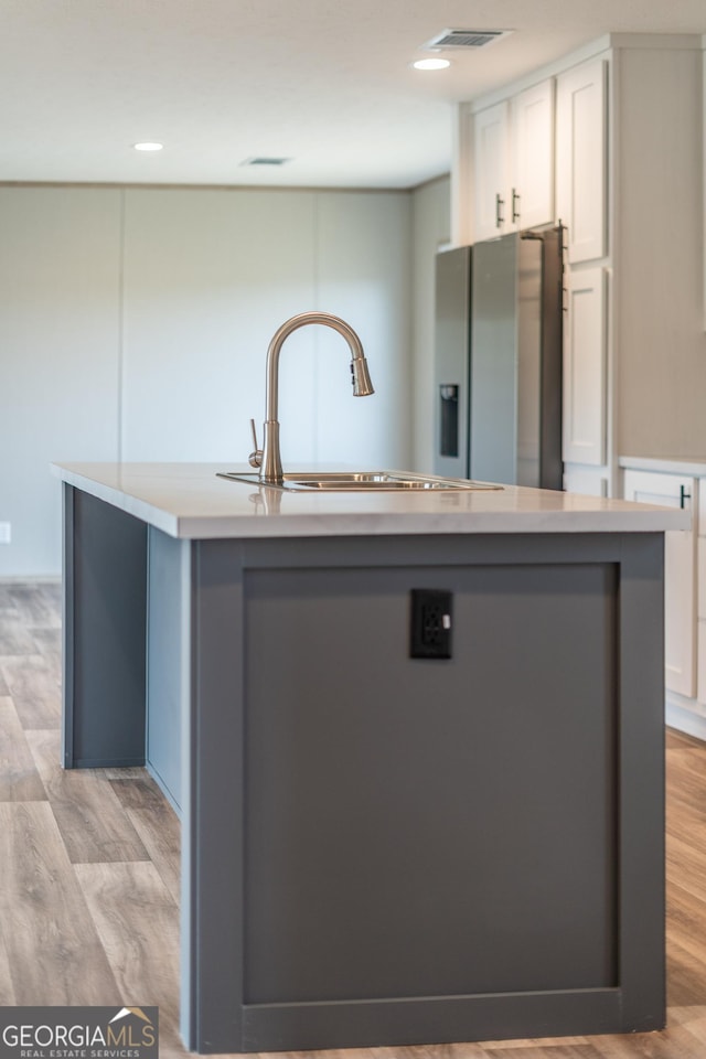 92 Wood Duck Ln, Folkston, GA 31537 - kitchen with visible vents, a sink, white cabinets, and stainless steel fridge with ice dispenser