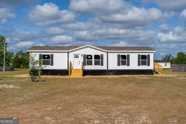 92 Wood Duck Ln, Folkston, GA 31537 - manufactured / mobile home featuring a shingled roof, entry steps, and a front lawn