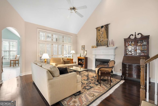 5 Renfroe Ct, Decatur, GA 30030 - living area with arched walkways, a ceiling fan, high vaulted ceiling, dark wood-style floors, and a fireplace