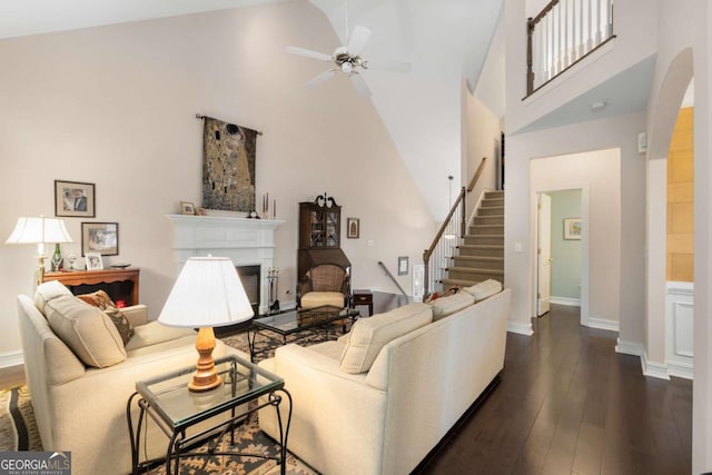 5 Renfroe Ct, Decatur, GA 30030 - living area featuring high vaulted ceiling, a ceiling fan, dark wood-style flooring, stairs, and a glass covered fireplace