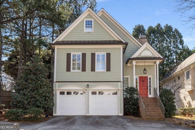 5 Renfroe Ct, Decatur, GA 30030 - view of front of home with a standing seam roof, driveway, an attached garage, and metal roof
