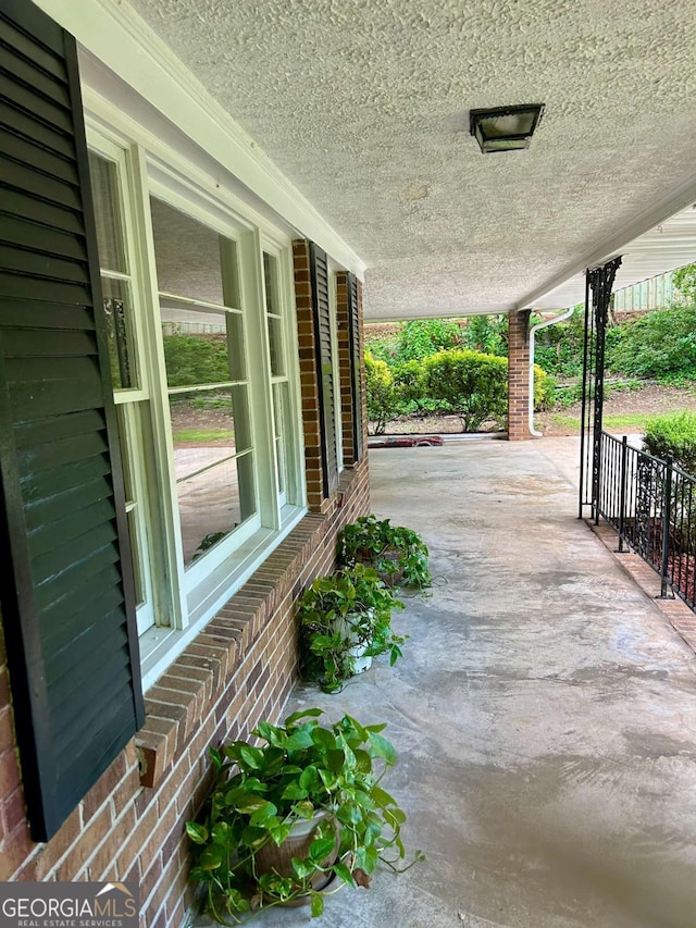 view of patio / terrace with covered porch and a carport
