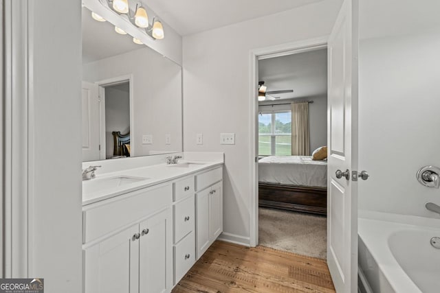 181 Sweet Briar Way, Homer, GA 30547 - ensuite bathroom with double vanity, wood finished floors, a bathtub, and a ceiling fan