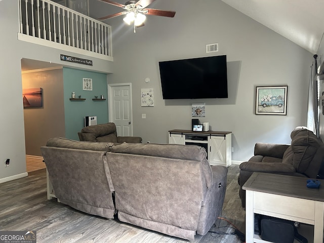 living area with ceiling fan, visible vents, wood finished floors, high vaulted ceiling, and baseboards