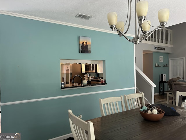 dining area with visible vents, crown molding, stairs, an inviting chandelier, and baseboards
