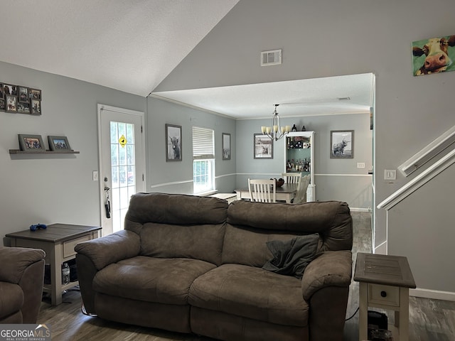living room with an inviting chandelier, baseboards, dark wood-style floors, and visible vents