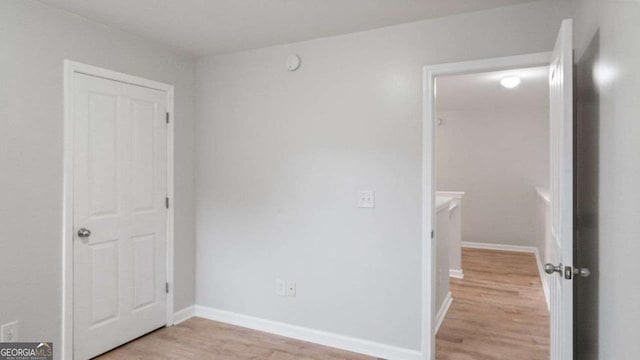 unfurnished bedroom with light wood-style floors and baseboards