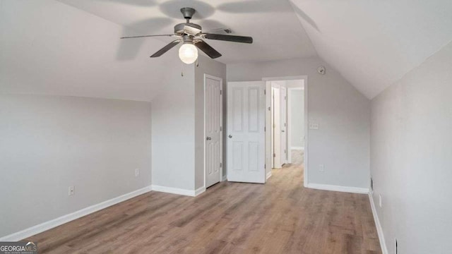 bonus room with wood finished floors, baseboards, ceiling fan, and lofted ceiling