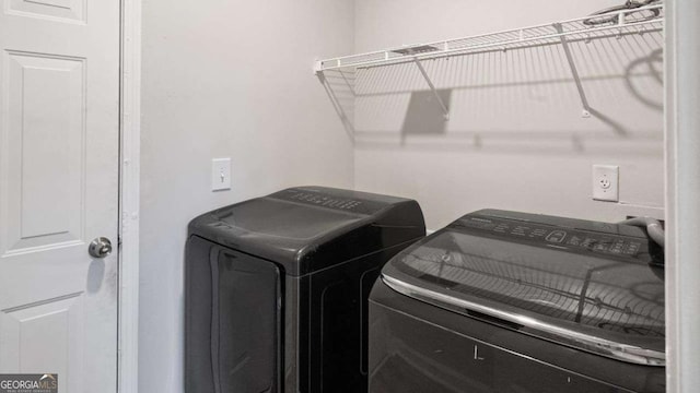 laundry room featuring independent washer and dryer and laundry area