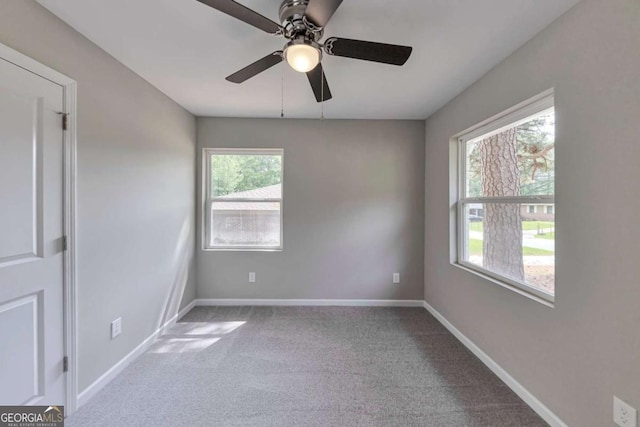 spare room featuring baseboards, carpet, and ceiling fan