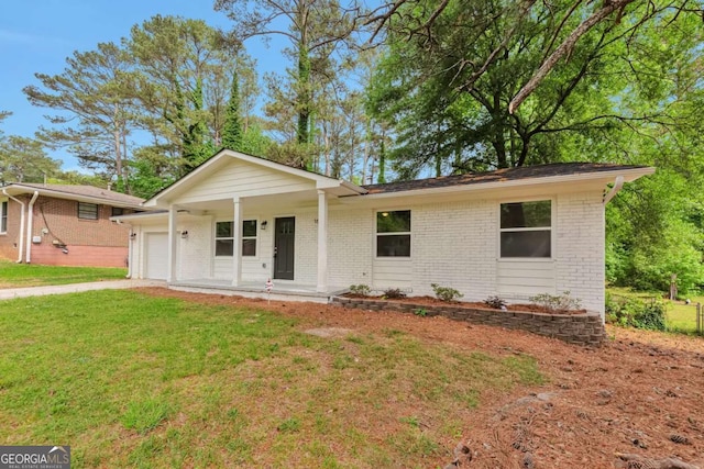 ranch-style house with brick siding, a garage, a front yard, and a porch