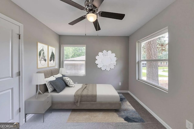 bedroom featuring a ceiling fan, baseboards, and carpet