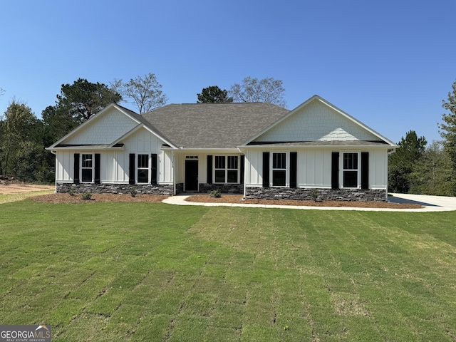 view of front of home with board and batten siding and a front yard