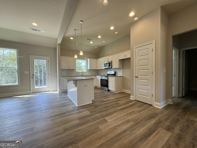 kitchen featuring white cabinets, stainless steel appliances, recessed lighting, a kitchen island, and visible vents