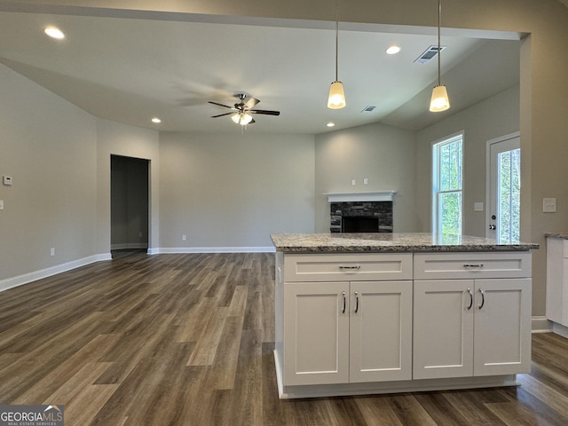 kitchen with a ceiling fan, dark wood-style flooring, baseboards, white cabinets, and open floor plan