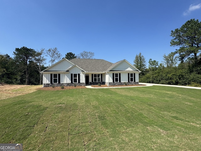 view of front facade featuring board and batten siding and a front yard
