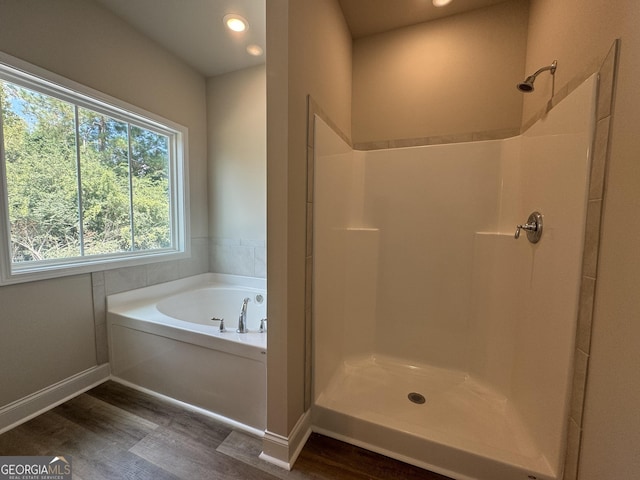 bathroom featuring a shower, a bath, recessed lighting, and wood finished floors