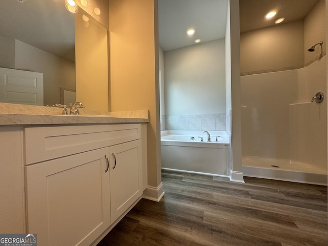 full bath featuring walk in shower, vanity, recessed lighting, wood finished floors, and a bath