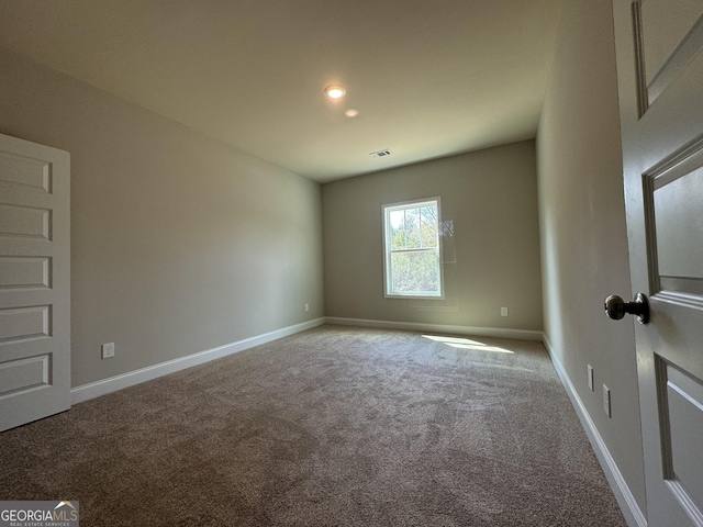 empty room with baseboards, carpet, and visible vents