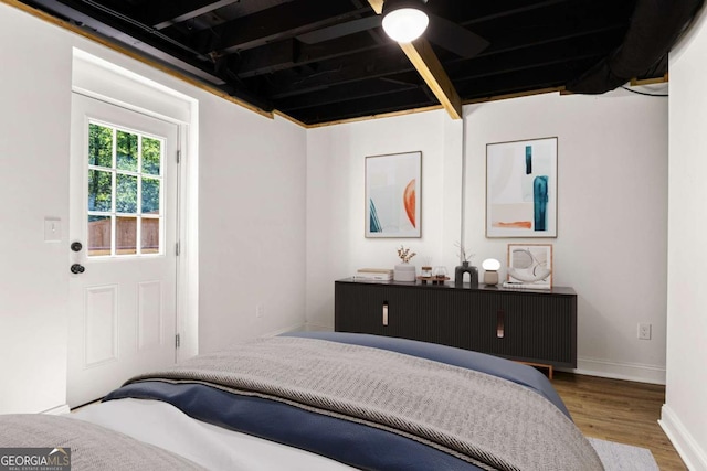 bedroom featuring baseboards and wood finished floors