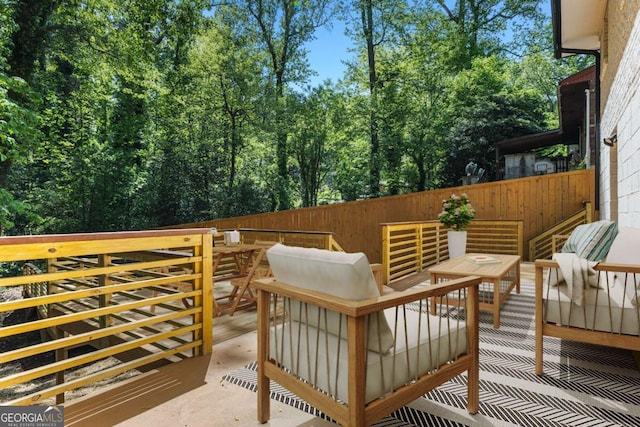 deck featuring fence and an outdoor living space