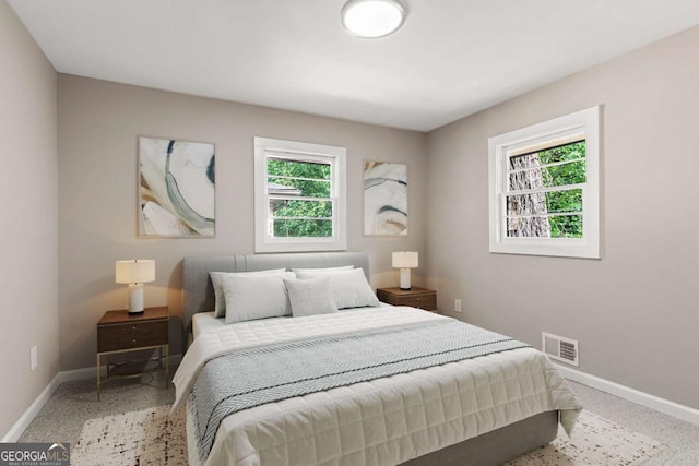 bedroom with visible vents and baseboards