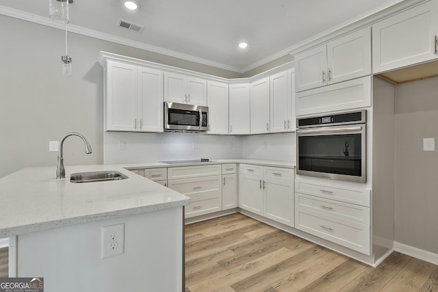 51 Camden Cir, Newnan, GA 30265 - kitchen featuring visible vents, crown molding, appliances with stainless steel finishes, a sink, and a peninsula