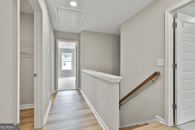 51 Camden Cir, Newnan, GA 30265 - corridor featuring baseboards, an upstairs landing, light wood finished floors, and attic access