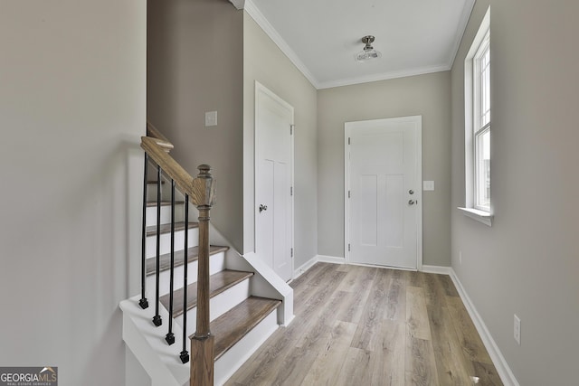 51 Camden Cir, Newnan, GA 30265 - entryway with crown molding, light wood-style floors, baseboards, and stairway