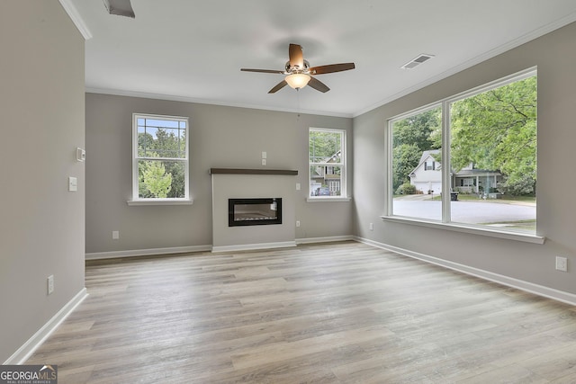 51 Camden Cir, Newnan, GA 30265 - unfurnished living room with ceiling fan, visible vents, crown molding, wood finished floors, and baseboards