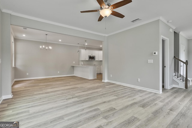 51 Camden Cir, Newnan, GA 30265 - unfurnished living room featuring baseboards, a sink, light wood-style flooring, and ceiling fan with notable chandelier