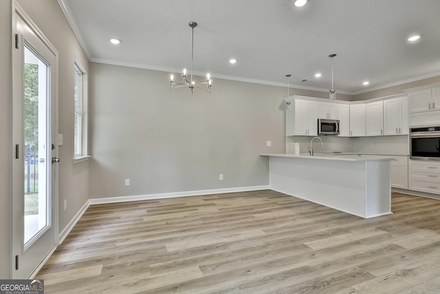 51 Camden Cir, Newnan, GA 30265 - kitchen with light countertops, appliances with stainless steel finishes, a notable chandelier, and a healthy amount of sunlight