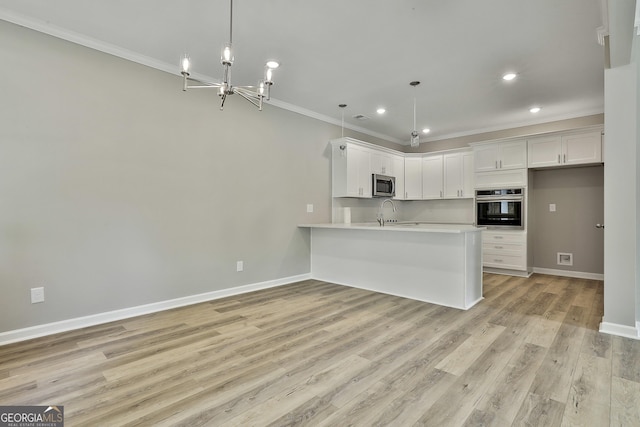 51 Camden Cir, Newnan, GA 30265 - kitchen with baseboards, ornamental molding, light wood finished floors, and appliances with stainless steel finishes