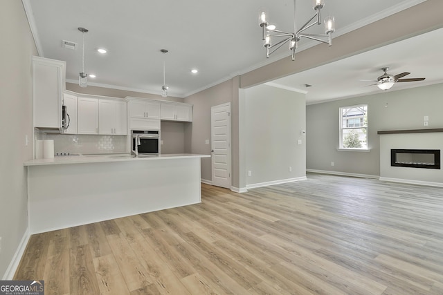 51 Camden Cir, Newnan, GA 30265 - kitchen with crown molding, light countertops, a peninsula, and stainless steel appliances