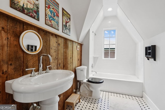 26 Clarendon Ave, Avondale Estates, GA 30002 - bathroom with vaulted ceiling, a sink, baseboards, toilet, and tub / shower combination