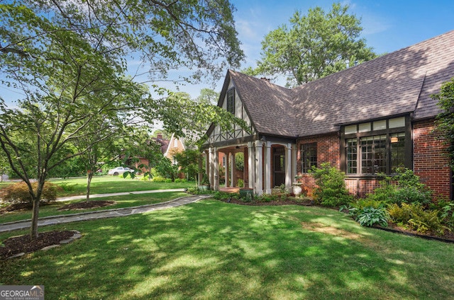 26 Clarendon Ave, Avondale Estates, GA 30002 - exterior space with a lawn, brick siding, and roof with shingles
