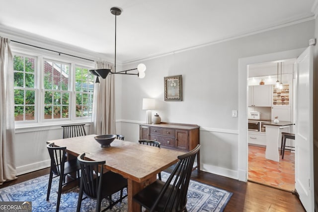 26 Clarendon Ave, Avondale Estates, GA 30002 - dining space featuring crown molding, baseboards, and dark wood-style flooring
