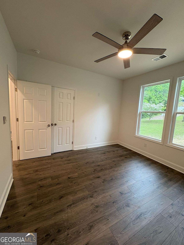 569 Tinker Bell Cir, Flintstone, GA 30725 - spare room with baseboards, ceiling fan, dark wood finished floors, and visible vents
