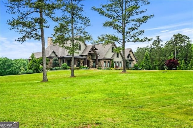 1101 N Flat Rock Rd, Douglasville, GA 30134 - view of front facade with stone siding, a chimney, and a front yard