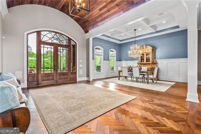 1101 N Flat Rock Rd, Douglasville, GA 30134 - entryway with a high ceiling, an inviting chandelier, a wainscoted wall, baseboards, and coffered ceiling