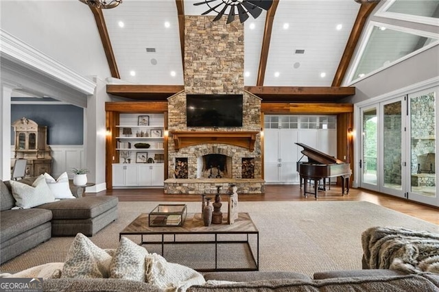 1101 N Flat Rock Rd, Douglasville, GA 30134 - living area with high vaulted ceiling, a stone fireplace, wood finished floors, and beam ceiling