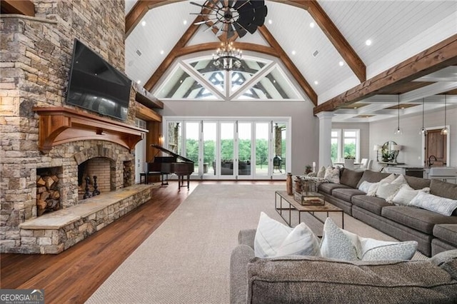 1101 N Flat Rock Rd, Douglasville, GA 30134 - living area with wood finished floors, beamed ceiling, a stone fireplace, high vaulted ceiling, and a chandelier