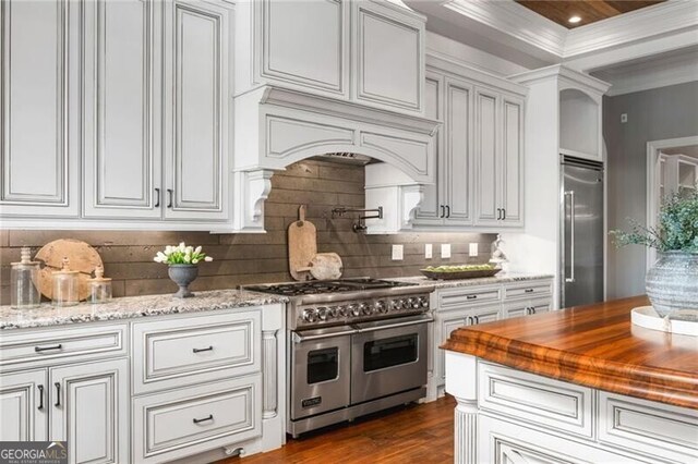 1101 N Flat Rock Rd, Douglasville, GA 30134 - kitchen featuring dark wood-style flooring, high quality appliances, light stone countertops, and tasteful backsplash