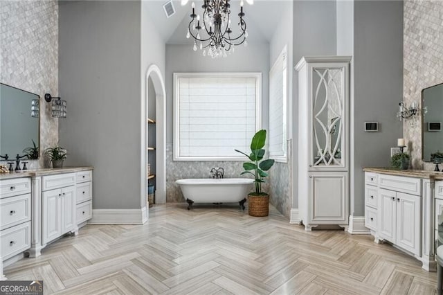 1101 N Flat Rock Rd, Douglasville, GA 30134 - full bathroom featuring a freestanding tub, vanity, a notable chandelier, and visible vents