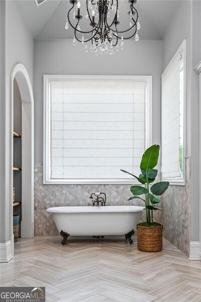 1101 N Flat Rock Rd, Douglasville, GA 30134 - bathroom with a freestanding tub, a notable chandelier, and a wealth of natural light