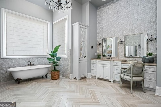 1101 N Flat Rock Rd, Douglasville, GA 30134 - bathroom featuring a freestanding tub, vanity, baseboards, an inviting chandelier, and wallpapered walls